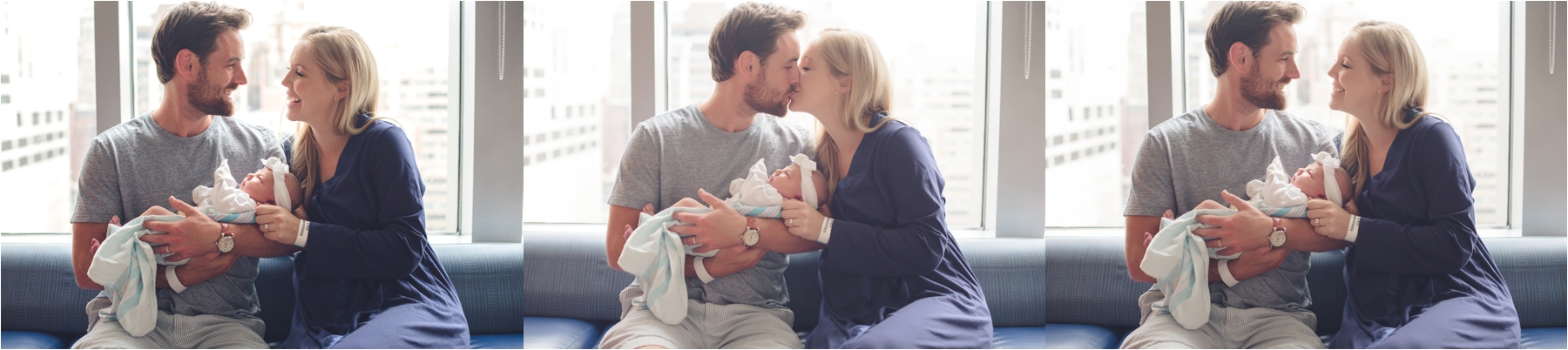 parents kiss with baby